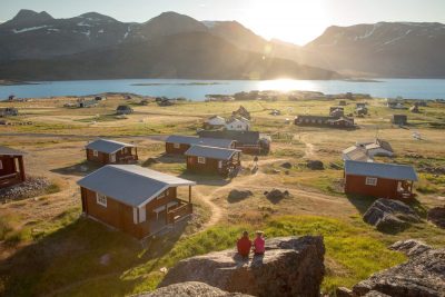 Two Guests Enjoying The Sunset At The Blue Ice Hut Accommodation In Igaliku In South Greenland 1400x933
